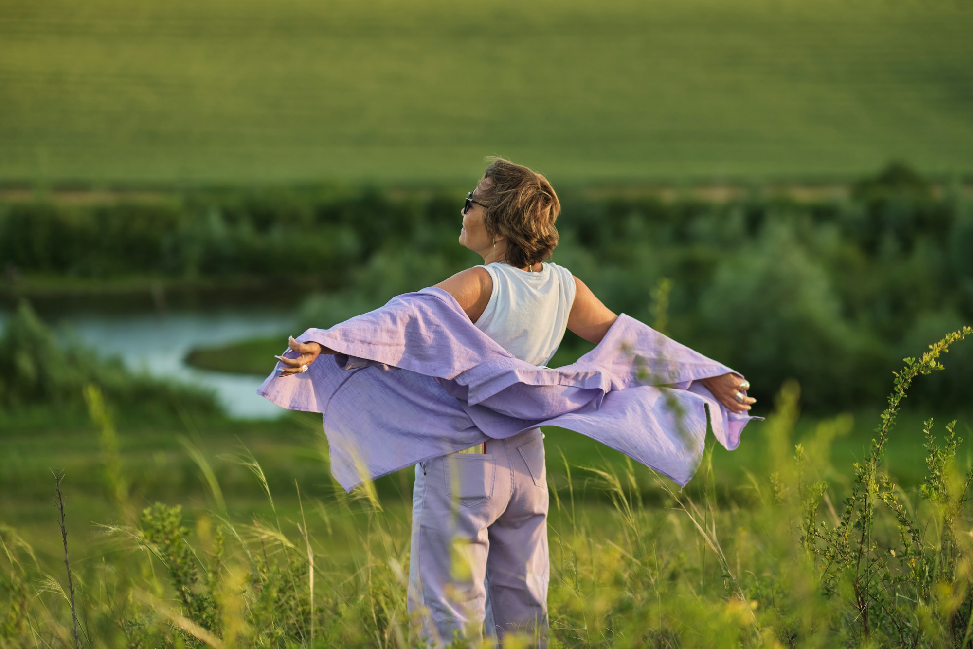 Image of a happy senior woman enjoying a day in nature, reflecting the high quality of life in